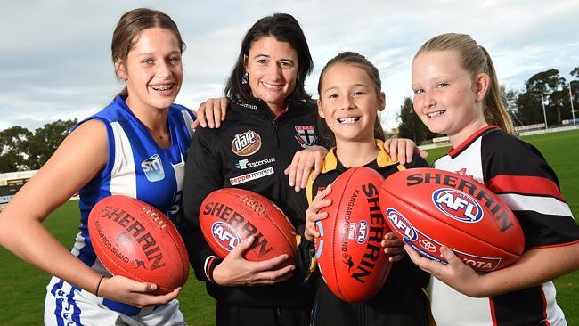 Saints assistant coach Peta Searle with junior footballers (from left) Emmy, Sophie and Mikayla are hoping for a women’s AFL team at St Kilda. Picture: Chris Eastman