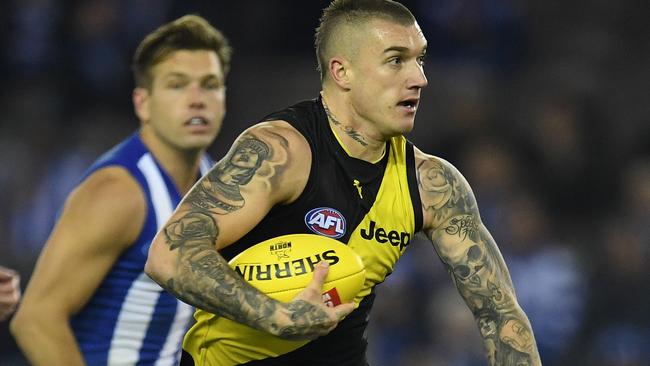 Dustin Martin of the Tigers (centre) is seen in action during the Round 11 AFL match between the North Melbourne Kangaroos and the Richmond Tigers at Etihad Stadium in Melbourne, Saturday, June 3, 2017. (AAP Image/Julian Smith) NO ARCHIVING, EDITORIAL USE ONLY