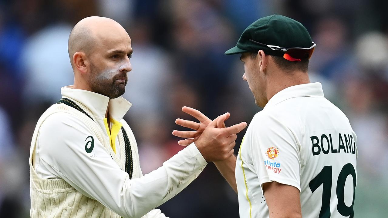 MELBOURNE, AUSTRALIA - DECEMBER 26: Scott Boland of Australia is congratulated by teammate Nathan Lyon after catching out Ollie Robinson of England to end the innings during day one of the Third Test match in the Ashes series between Australia and England at Melbourne Cricket Ground on December 26, 2021 in Melbourne, Australia. (Photo by Quinn Rooney/Getty Images)