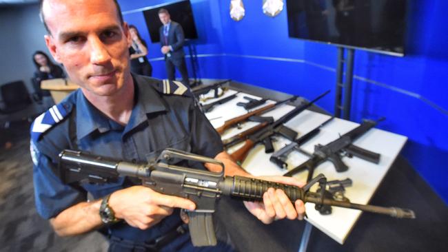 Leading Senior Constable Jon Bamford with an M4. Picture: Tony Gough