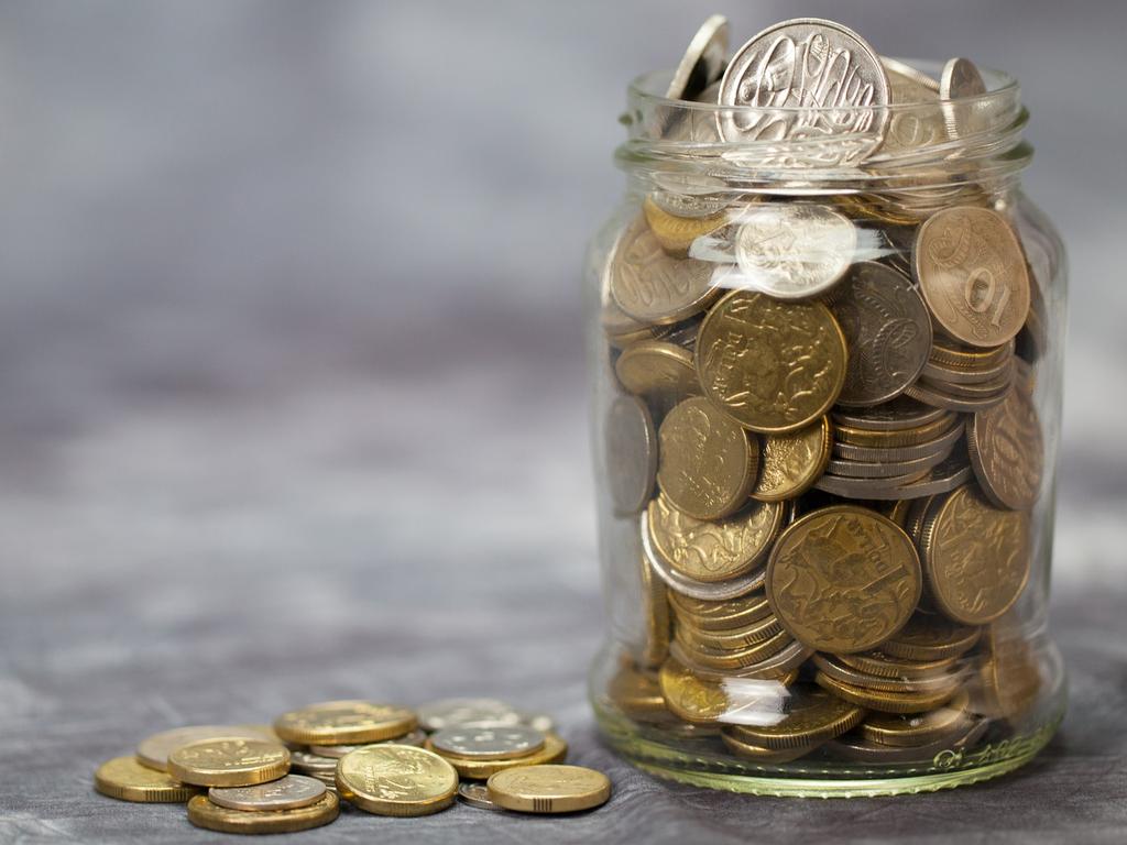 A glass jar full of Australian coins. Potential concept for savings, holiday fund, donations, charity, generosity. Money generic, Copy space.