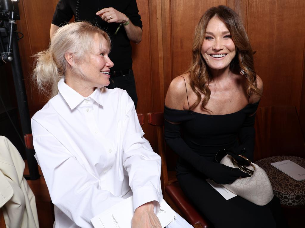 Pamela Anderson and Carla Bruni share the front row at the Jacquemus Menswear Fall-Winter 2025/2026 show. Picture: Pascal Le Segretain/Getty Images