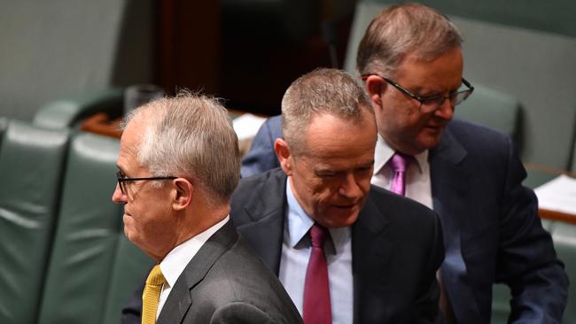 Prime Minister Malcolm Turnbull and Opposition leader Bill Shorten cross paths in Parliament. Picture: AAP/Mick Tsikas