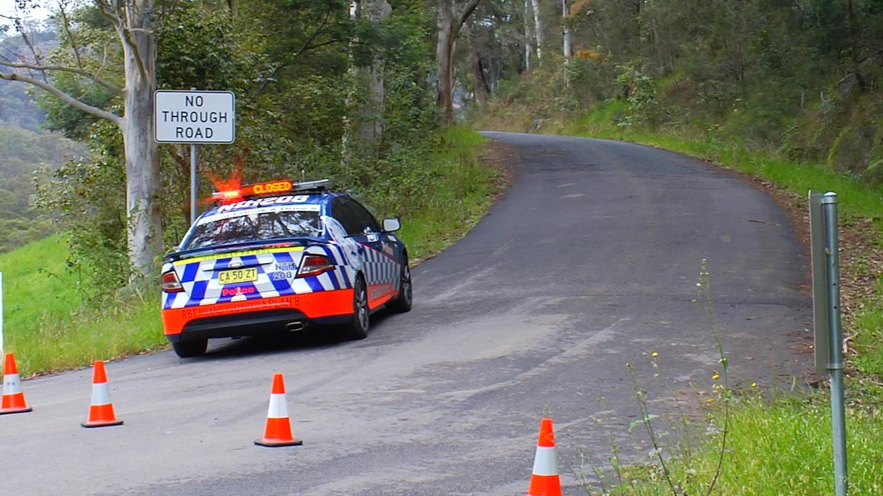 Police car on the scene at Mangrove Creek Road after the discovery of a dumped body. Picture: David Cleverly.