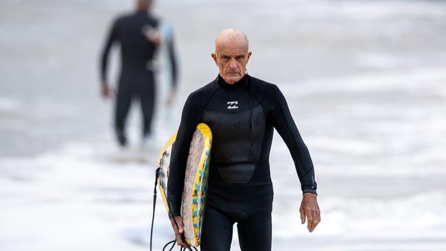 Jon Winfield, now aged 69, surfing at Sharpes Beach. Picture: Liam Mendes / The Australian