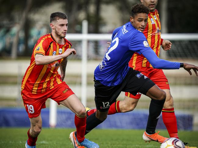 Adelaide Comets player Tete Yengi leads Metro Stars opponent Cooper O'Donnell to the ball during a match in September last year. Picture: Mike Burton