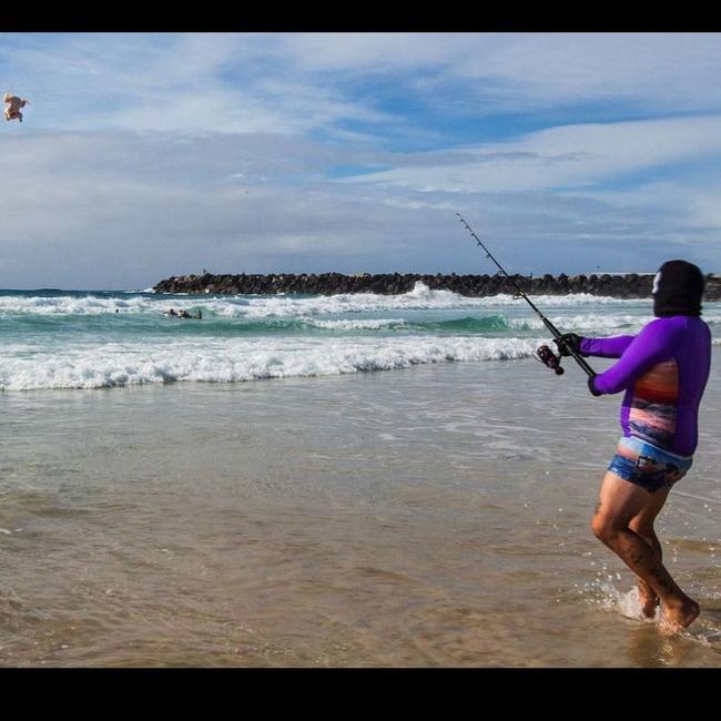 Willem Ungermann, aka Willem Powerfish, fishes at the beach with a whole chook.