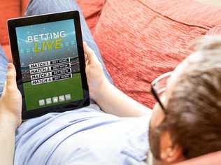 Man betting online on a tablet. Picture: milindri