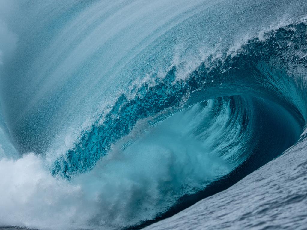 A huge wave dumps surf in Tahiti. Picture: Tim McKenna