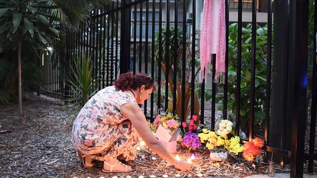 Shae Francis’ mother, Cheryl-Lee Francis, lighting a candle at the shrine left for Shae outside her home in Hervey Bay. Picture: Cody Fox