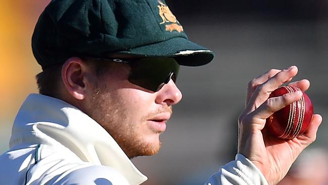 Steve Smith holds the ball on day three of the first Test cricket match between Pakistan and Australia at the Gabba in Brisbane. Picture: Saeed Khan / AFP