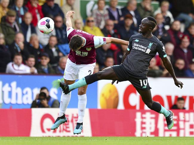 Burnley's Matthew Lowton, left, and Liverpool's Sadio Mane battle for the ball. Picture: Anthony Devlin/PA via AP