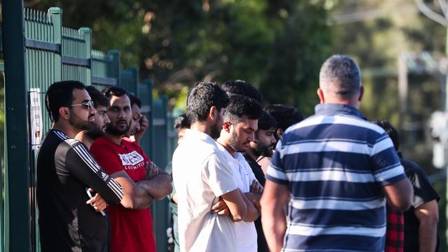 Friends of the male who was fatally killed in the fire watch on as emergency services conduct an investigation into what caused the house fire. NewsWire/ Gaye Gerard