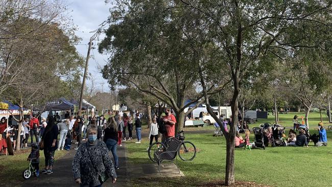 Shoppers swarm to a farmers market at Beaton Reserve, Yarraville, with one large group congregating for a picnic. Picture: Brianna Travers