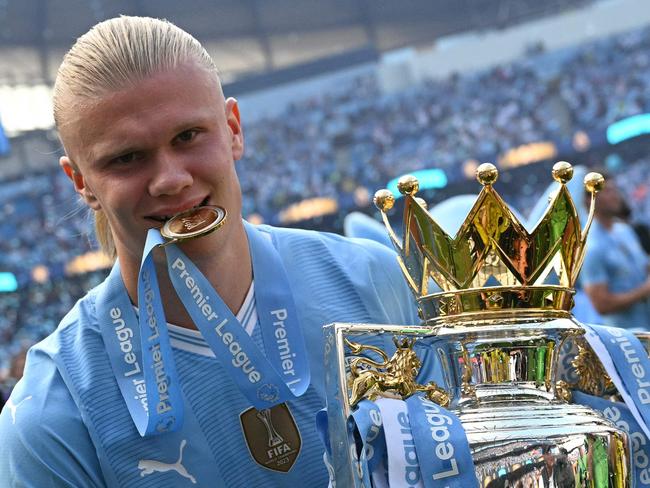 (FILES) Manchester City's Norwegian striker #09 Erling Haaland poses with the Premier League trophy after the presentation ceremony following the English Premier League football match between Manchester City and West Ham United at the Etihad Stadium in Manchester, north west England, on May 19, 2024. Erling Haaland has signed a 10-year contract that will keep him at the Etihad Stadium until 2034, the club announced Friday January 17. (Photo by Oli SCARFF / AFP) / RESTRICTED TO EDITORIAL USE. No use with unauthorized audio, video, data, fixture lists, club/league logos or 'live' services. Online in-match use limited to 120 images. An additional 40 images may be used in extra time. No video emulation. Social media in-match use limited to 120 images. An additional 40 images may be used in extra time. No use in betting publications, games or single club/league/player publications. /