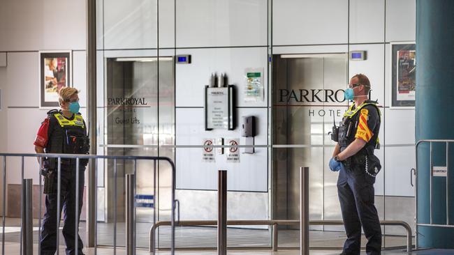 Police outside the Park Royal Hotel at Melbourne Airport after two separate resident groups on the same floor returned genome testing results for the same UK variant Picture: David Geraghty