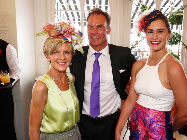 Julie Bishop and her partner David Panton talk to Frances Abbott in the Emirates marquee in the Birdcage at Flemington Racecourse during the 2014 Melbourne Cup.