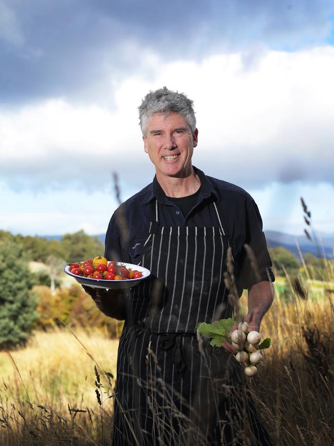 Gourmet Farmer Matthew Evans holds a plate of harvested garden tomatoes and turnips at Fat Pig Farm in 2017. Picture: Luke Bowden