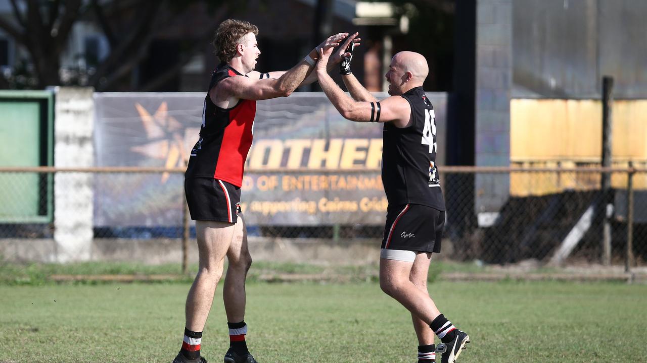 Jarrod Peake celebrates kicking a goal with teammate Adam Gross in the AFL Cairns seniors match between the Cairns Saints and the South Cairns Cutters, held at Griffiths Park, Manunda. Picture: Brendan Radke