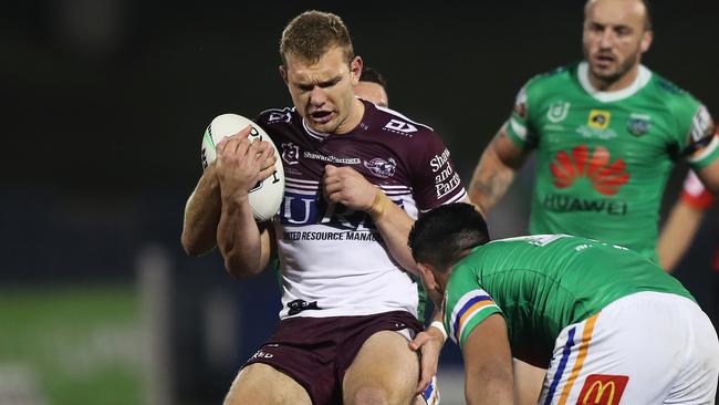 Manly's Tom Trbojevic clutches at his hamstring after an awkward run in his sides win over the Raiders. Picture: Brett Costello.