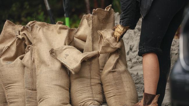 Placing sandbags at the entry point of your home can prevent floodwater entering. Picture: NewsWire / Glenn Campbell