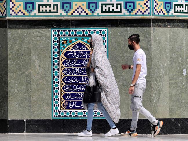 Iranian Shiite Muslims arrive to pray at the Emamzadeh Saleh mosque in Tajrish square in northern Tehran on April 3, 2022, on the first day of the holy fasting month of Ramadan in the Islamic Republic. (Photo by ATTA KENARE / AFP)