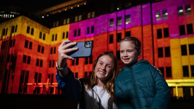 Emily Farrell, 12, and Phoenix Drivas, 5, snap a selfie outside the Vivid centrepiece at the Museum of Contemporary Art. Picture: Paul McMillan