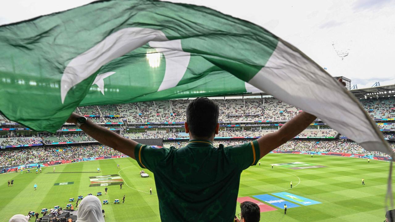 A Pakistan supporter waves the national flag. Photo by WILLIAM WEST / AFP