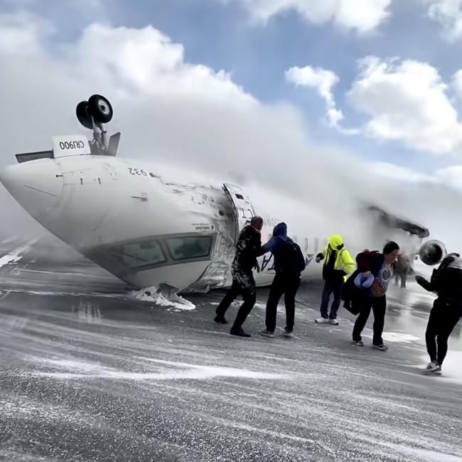 Images shot by passenger Pete Koukov who was on a Delta Air Lines plane that crashed while landing Monday afternoon at the snowy Toronto Pearson International Airport. Picture: Pete Koukov/@eggxit Instagram