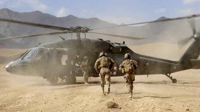 Australian Sergeant Medic Bernadette Serong escorts a casualty to the Aero medical Evacuation (AME) helicopter for transportation back to Tarin Kowt medical facility in Afghanistan. Picture: Channel 7