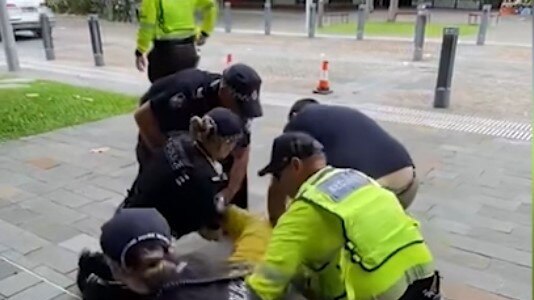 A man has been charged after allegedly punching a police officer in the head during a press conference in 2023.