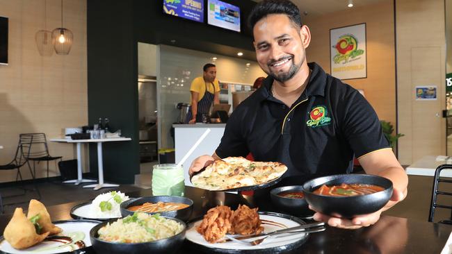 Regional manager of Spicy Bite Jatinder Singh Jeetu serves up a smorgasbord selection of Indian curries, rice and naan bread. Picture: Brendan Radke