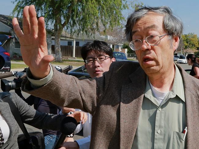 Dorian S. Nakamoto, identified by Newsweek magazine as the founder of Bitcoin, exits his home surrounded by members of the media on Thursday, March 6, 2014.