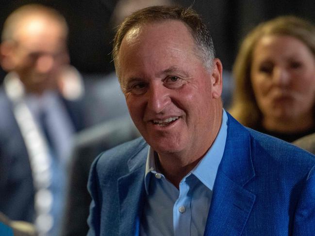 This picture taken on October 14, 2023 shows former New Zealand Prime Minister John Key meeting with guests during New Zealand's National Party leader Christopher Luxon address to his supporters after winning the 2023 New Zealand general election in Auckland. Luxon was poised to be the country's 42nd leader after his centre-right National Party secured a large lead in general elections. (Photo by Ivan Tarlton / AFP)