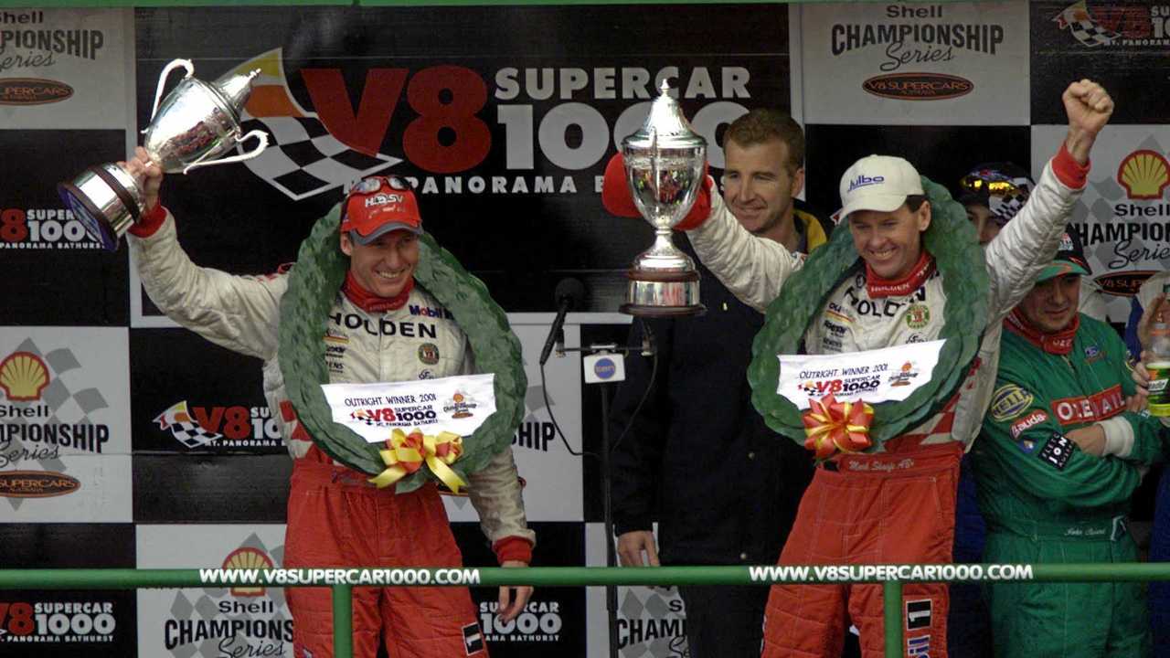 WINNERS: Holden Racing Team drivers Mark Skaife (L) and Tony Longhurst (R) celebrate on the podium after winning the 2001 V8 Supercar Bathurst 1000. Picture: MARK HORSBURGH