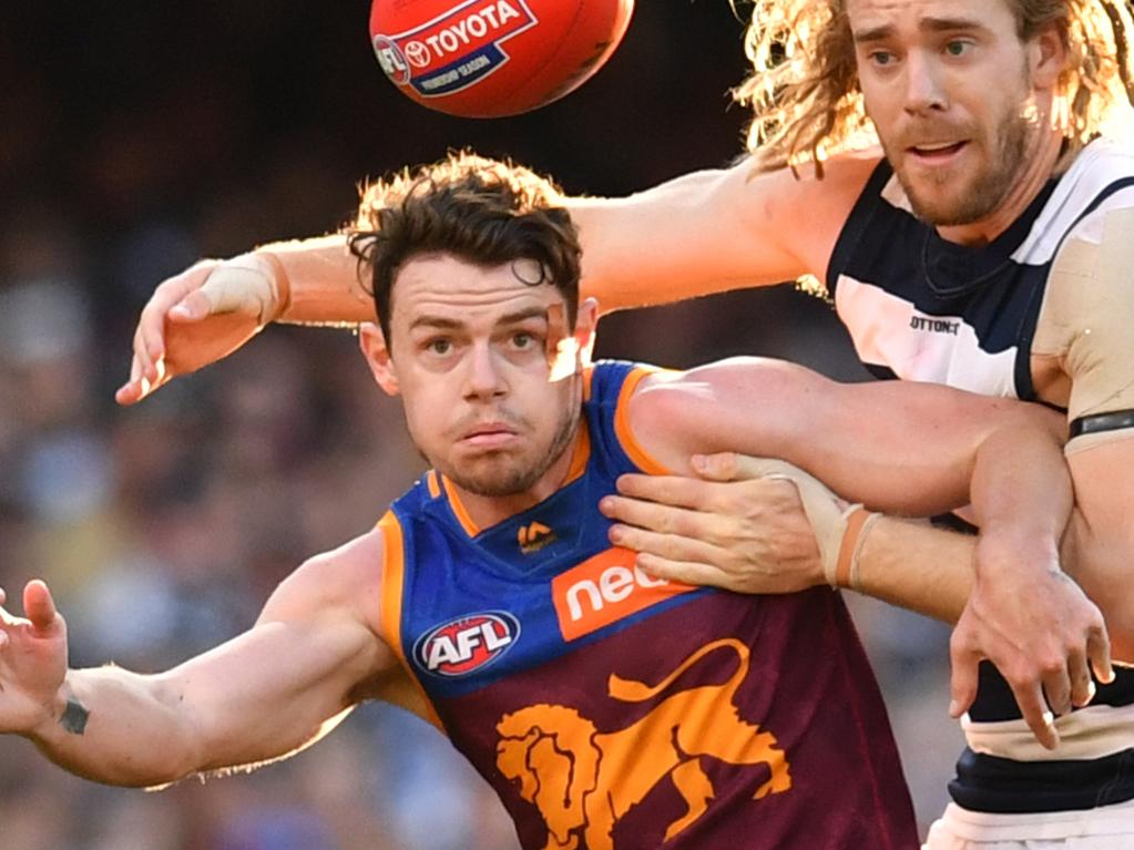 Lachie Neale (left) of the Lions contests for the ball against Cameron Guthrie (right) of the Cats during the Round 22 AFL match between the Brisbane Lions and the Geelong Cats at the Gabba in Brisbane, Saturday, August 17, 2019.  (AAP Image/Darren England) NO ARCHIVING, EDITORIAL USE ONLY