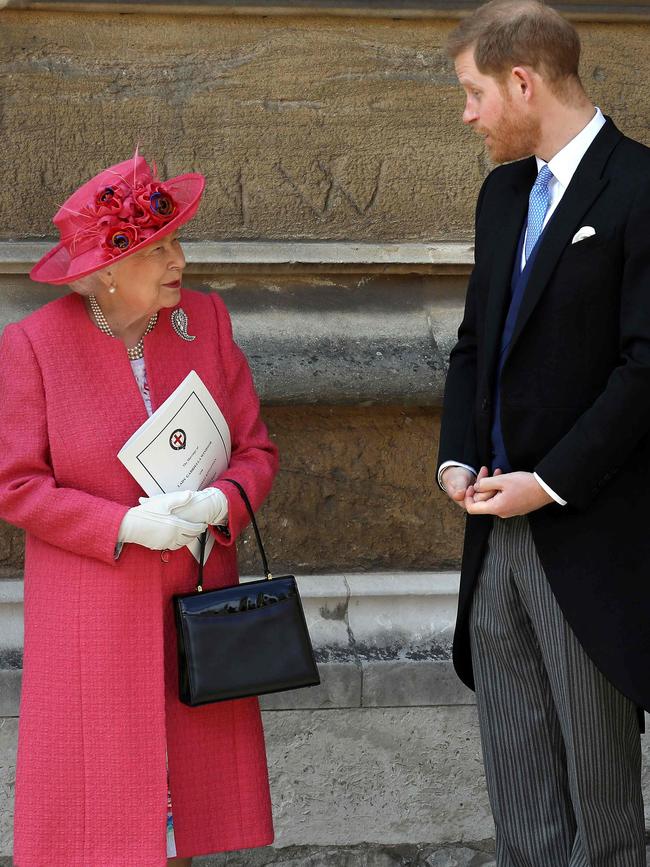 Britain's Queen Elizabeth II (L) and Britain's Prince Harry. Picture: AFP