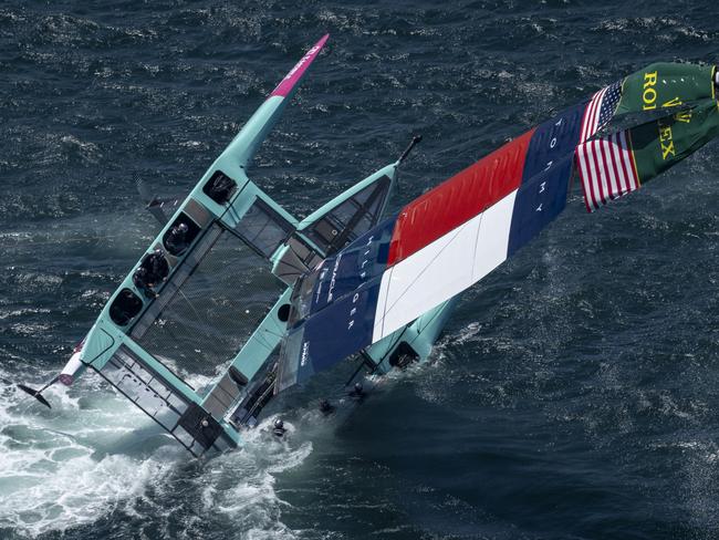 The USA SailGP Team F50 catamaran is recovered by a support crew after it capsized whilst being towed on to the race area for a practice session ahead of the KPMG Australia Sail Grand Prix in Sydney, Australia. Friday 7 February 2025. Rolex SailGP Championship Event 3 Season 2025. Photo: Jon Buckle for SailGP. Handout image supplied by SailGP