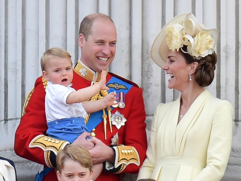 Britain's Prince William, Duke of Cambridge holding Prince Louis, Prince George, Princess Charlotte and Britain's Catherine, Duchess of Cambridge stand with other members of the Royal Family on the balcony of Buckingham Palace. Picture: AFP