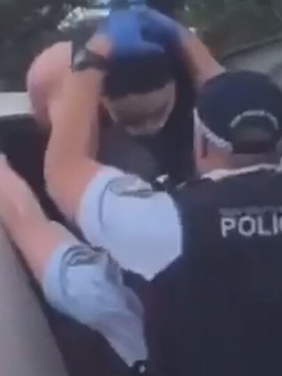 Police handcuffed her and placed a mask over her mouth.