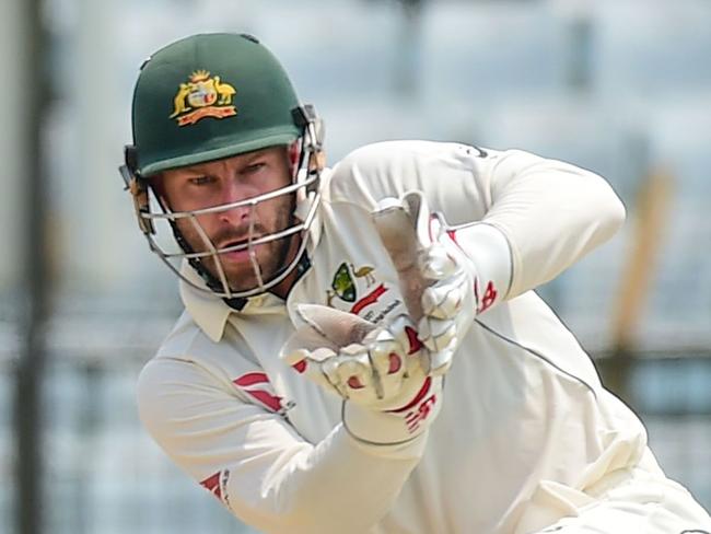 Bangladeshi batsman Mominul Haque (L) plays a shot in front of Australian wicketkeeper Matthew Wade (R) during the first day of the second cricket Test match between Bangladesh and Australia at Zahur Ahmed Chowdhury Stadium in Chittagong on September 4, 2017. / AFP PHOTO / Munir UZ ZAMAN