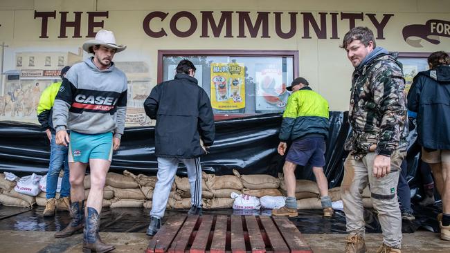 Locals protect the IGA in Rochester. Picture: Jason Edwards