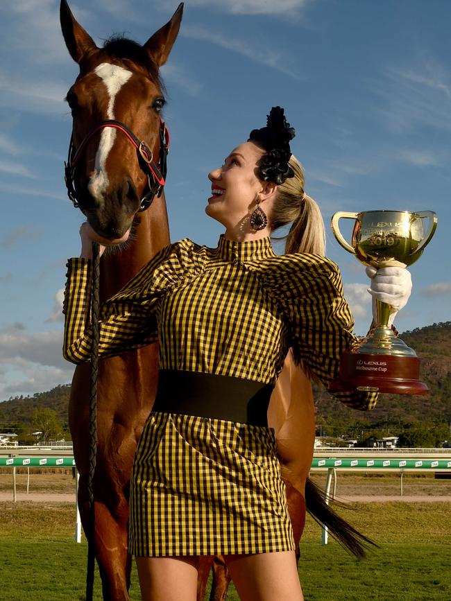 Chantelle O'Neil with the Melbourne Cup, the Townsville Cup and Unbiased who is running in the Townsville Cup. Picture: Evan Morgan.