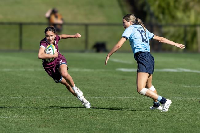 Nikeisha Ngaru (QLD) getting past her NSW opponent during the Grand Final of the Open Girls Sevens at the Australian Schools Rugby Championships. Picture: Anthony Edgar.