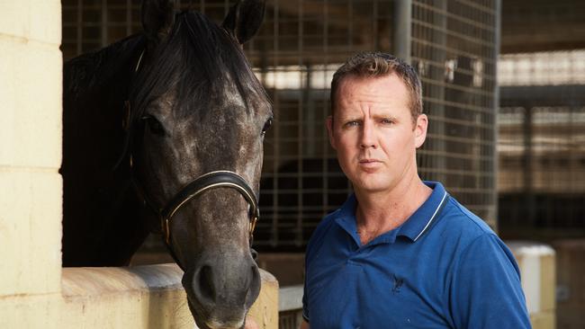 Travis Doudle poses for a picture with one of his horses at his stables. Picture: Matt Loxton