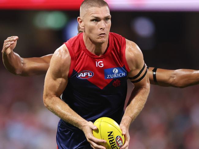 SYDNEY, AUSTRALIA - MARCH 07:  Adam Tomlinson of the Demons handles the ball during the Opening Round AFL match between Sydney Swans and Melbourne Demons at SCG, on March 07, 2024, in Sydney, Australia. (Photo by Matt King/AFL Photos/Getty Images)