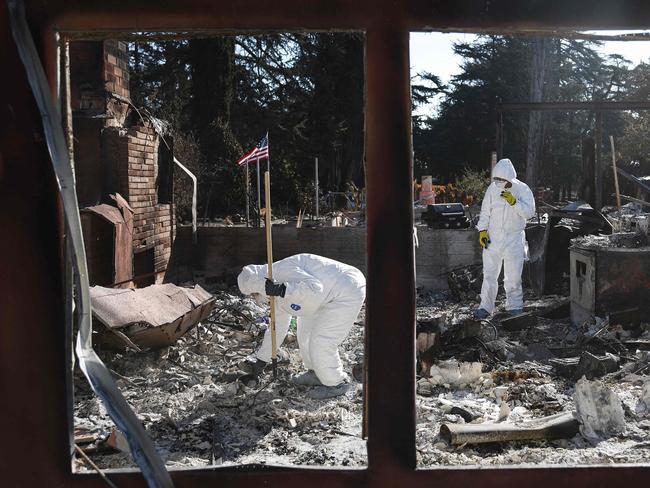 Nick Sonnenburg and his parents search for personal items to recover from the remains of his apartment which burned in the Eaton Fire. Picture: Getty Images via AFP