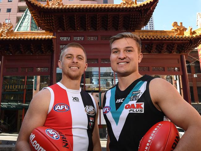 Ollie Wines of Port Adelaide Power (right) and Seb Ross of Saint Kilda Saints pose for a photo in Little China Town in  in Melbourne, Tuesday, October 25, 2018. The AFL today announced Port Adelaide and St.Kilda will play a home and away game in China for the three years from 2019. (AAP Image/Julian Smith) NO ARCHIVING