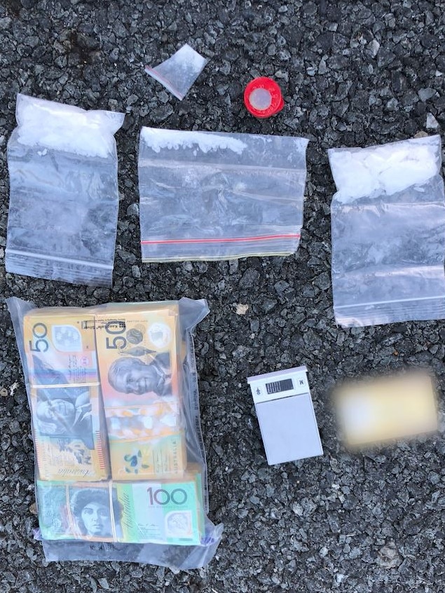 Money and drugs allegedly found by police at the scene.