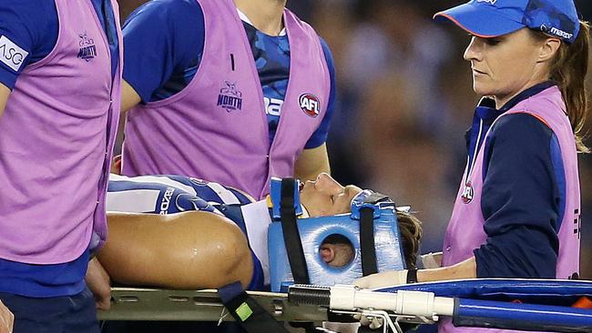 North Melbourne’s Shaun Higgins is taken from the field after a head clash. Picture: Michael Klein